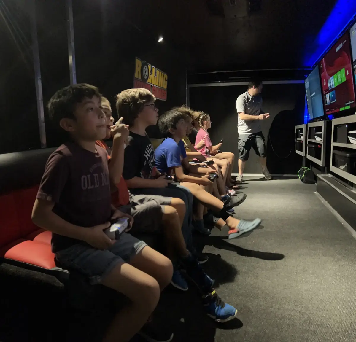 Players seated at gaming stations inside the game truck