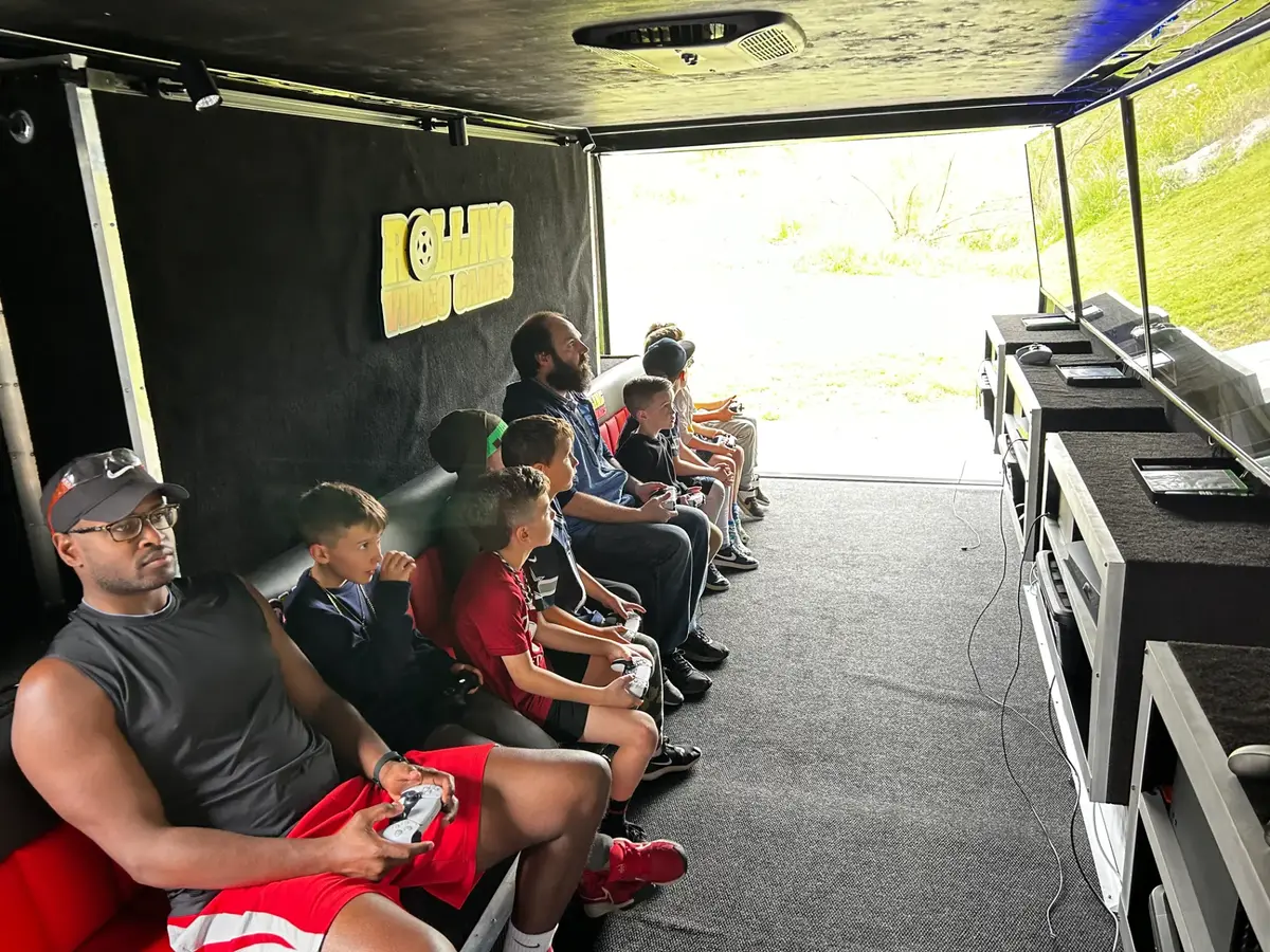 Kids gaming inside the trailer at a birthday party