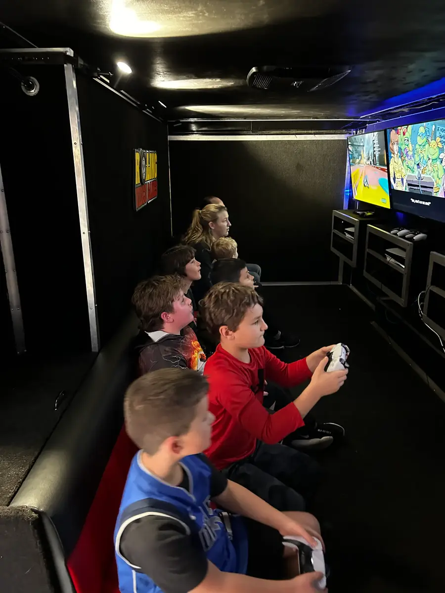 Group gathered around game truck screens