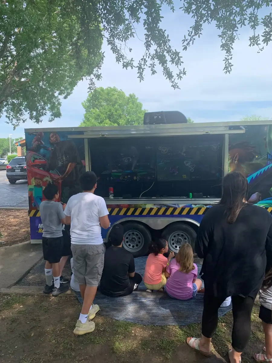 Party guests gaming together inside the climate-controlled trailer