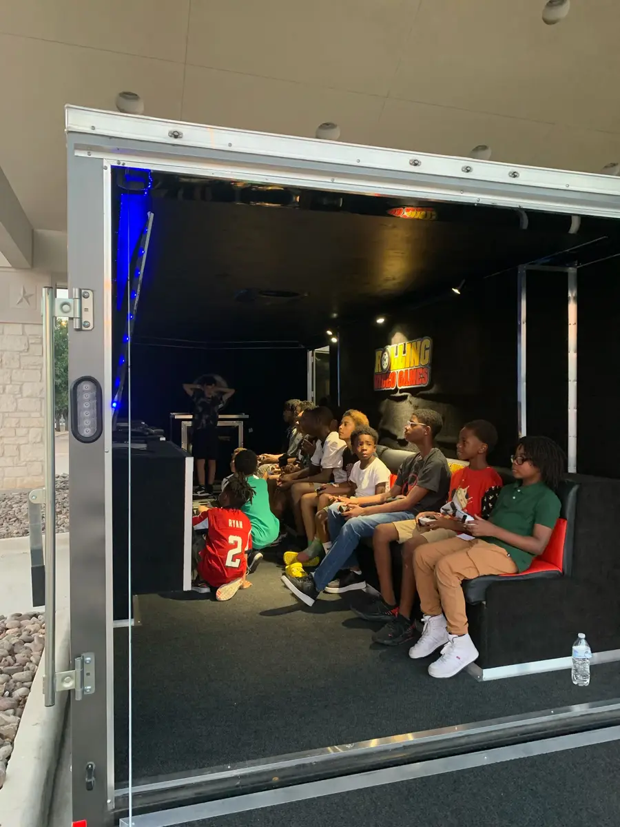Kids taking turns on the gaming stations
